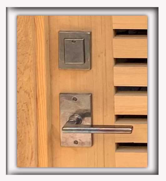 cropped photo showing close-up of gate with bronze gate hardware Rocky Mountain Hardware solid bronze dead bolt DB250