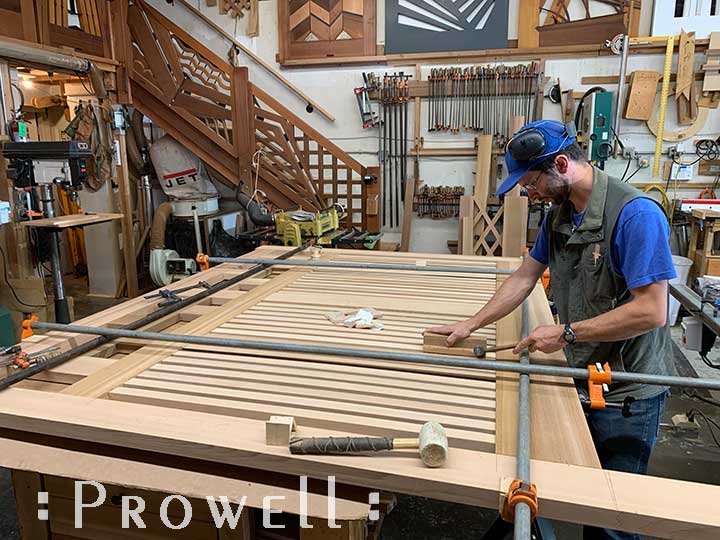 shop progress photograph showing ben prowell aligning the horizontal driveway gates #11-1pickets for the 