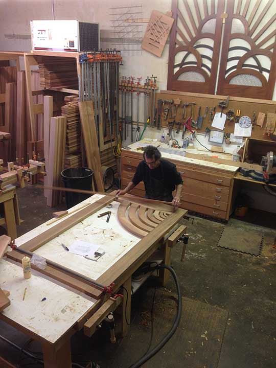 shop photograph showing charles prowell designing the modern wood gate #206
