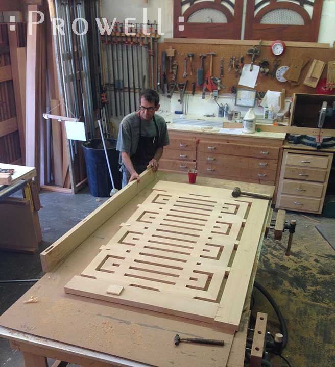 Charles Prowell in the shop clamping the final stages of wood garden gate #207