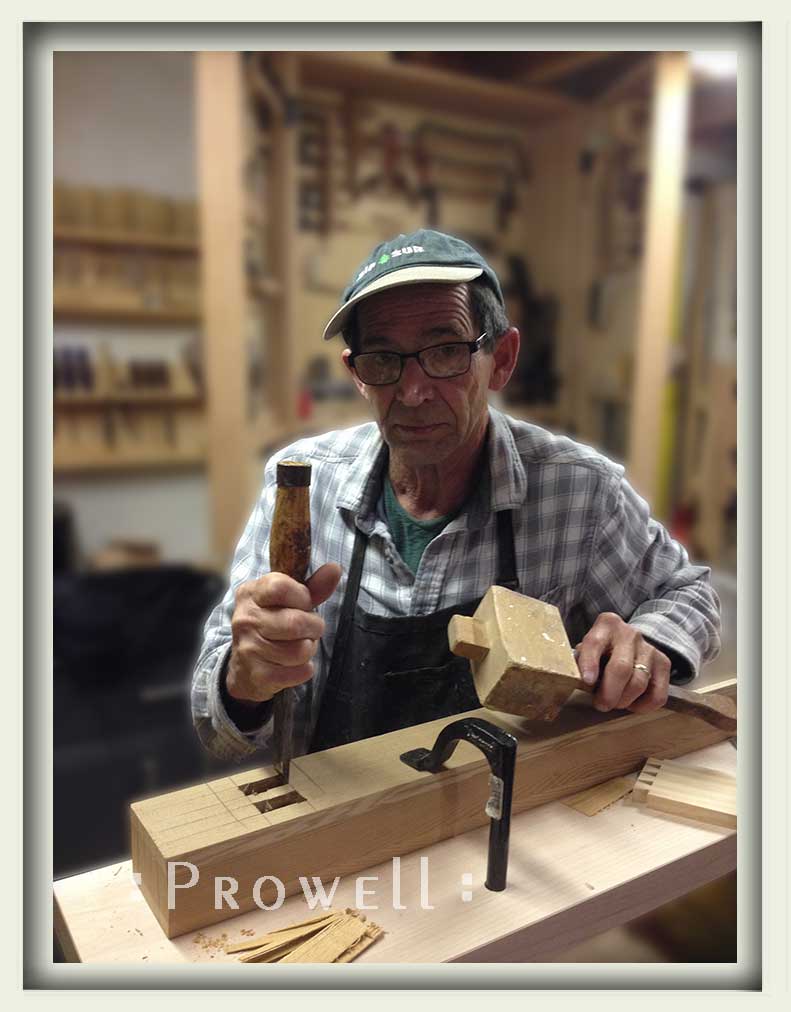 shop photograph showing Charles Prowell hand-cutting a mortise for the artistic garden gates #208