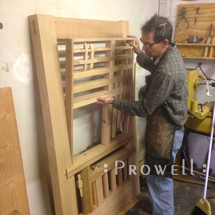 shop photograph showing Charles assembling the upper section to the artistic garden gate #208
