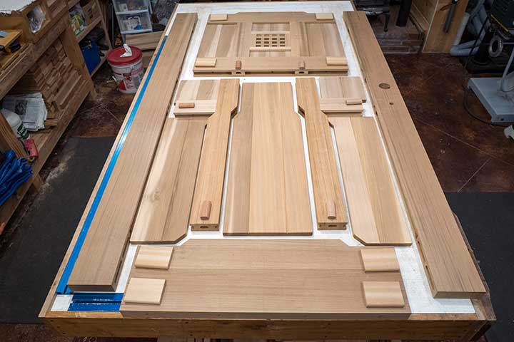 shop photo showing the various parts to wood gates #92 on the workbench