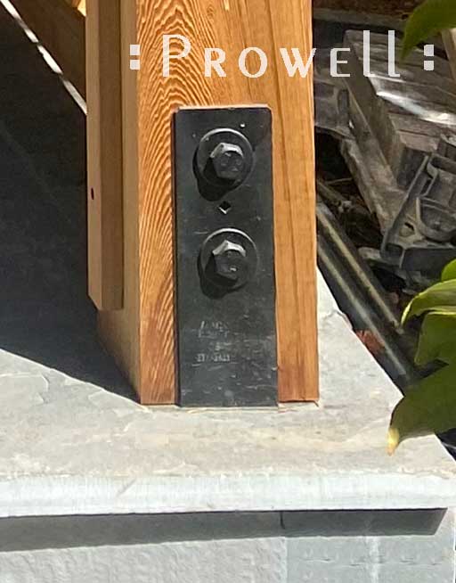 gatepost brackets into stone slabs.