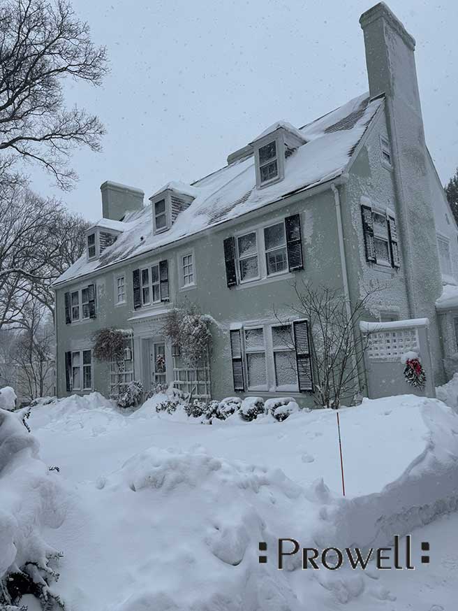 Wood gates and fence in snowstorm, Boston.