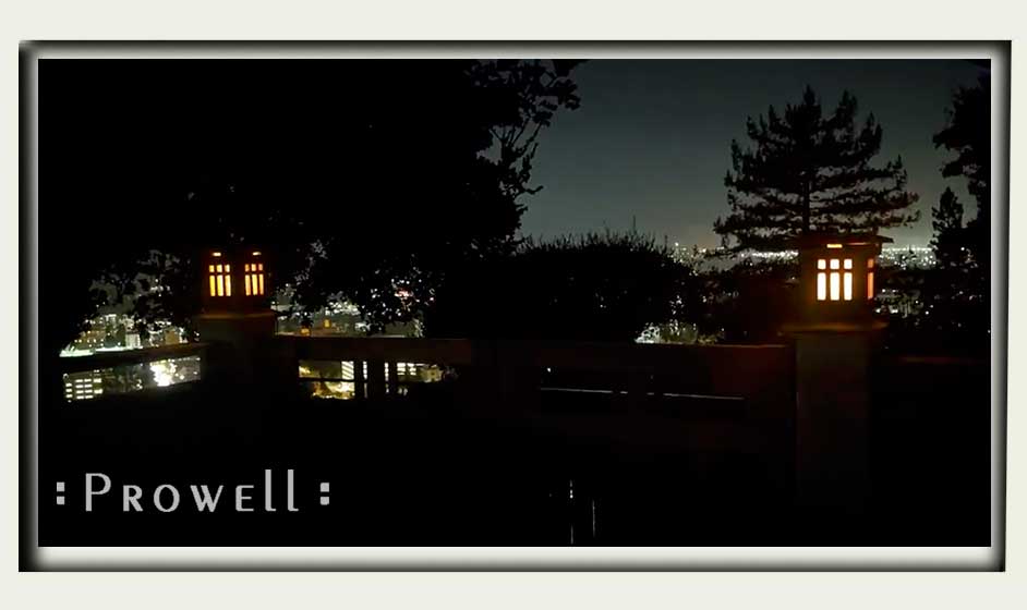 wood lighting columns mounting to gate pillars. Evening photo. Berkeley, CA